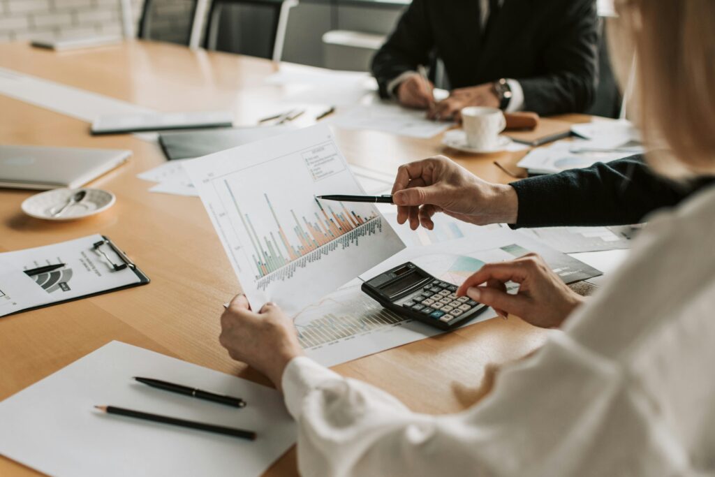 Professionals reviewing financial graphs and charts during a meeting.