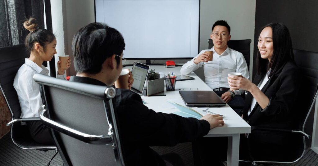 Group of professionals engaged in a collaborative meeting in a modern office setting.